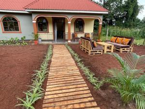 una pasarela de madera frente a una casa en Home Feeling Kilimanjaro, en Moshi