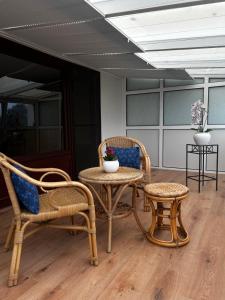 a room with two chairs and a table and a stool at Nord Haus in Kiel