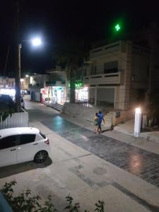 a white car parked on a street at night at Renia Studios in Agia Pelagia