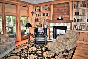 a living room with chairs and a fireplace at Good Wood 3BR Walking distance to restaurants and shops along the waterfront of Winyah Bay in Georgetown