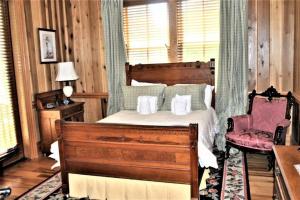 a bedroom with a bed and a chair at Good Wood 3BR Walking distance to restaurants and shops along the waterfront of Winyah Bay in Georgetown