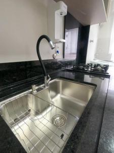 a kitchen sink with a faucet on top of it at Apto Germano Praia in Balneário Camboriú