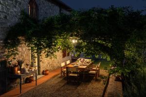 a table and chairs in a garden at night at Podere Del Boscaccio in Pistoia