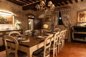 a dining room with a table and chairs at Podere Del Boscaccio in Pistoia