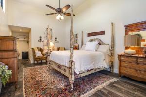 a bedroom with a bed and a ceiling fan at Inn at Sunset Mill Ranch in Wimberley