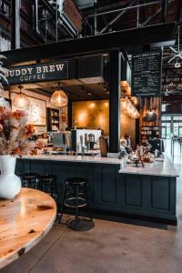 a coffee shop with a counter and stools in it at Charming 2-Bedrooms Central Clearwater Apartment With Private Backyard in Clearwater