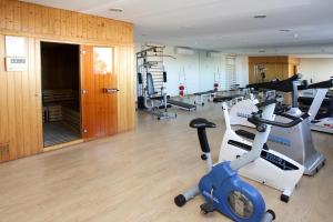 a gym with treadmills and machines in a room at Hotel Albufera in Alfafar