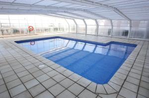 a large swimming pool in a building at Hotel Albufera in Alfafar