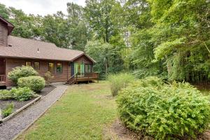 a log cabin with a bench in the yard at Fully Remodeled Saugerties Retreat on 7 Acres! in Saugerties