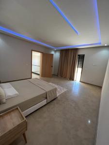 a large room with a bed and a blue light at Marrakech Luxury Villa 