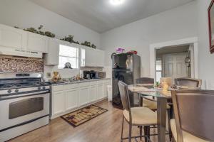 a kitchen with white cabinets and a table with chairs at Charming San Antonio Home 5 Mi to Downtown! in San Antonio