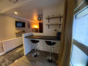 a kitchen with two bar stools and a counter at La Grelauderie 3 in Saintes