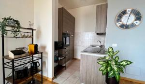 a kitchen with a sink and a clock on the wall at - ARENA - Panoramic VIEW - Central Apartment in Verona