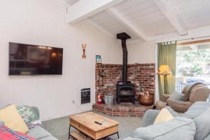 a living room with two couches and a fireplace at 451 - Mountain Retreat w Pool Fireplace Tennis Courts More in Mammoth Lakes