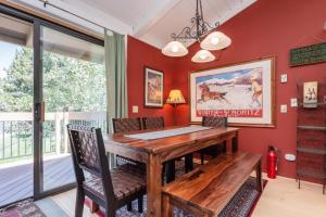 a dining room with a wooden table and chairs at 451 - Mountain Retreat w Pool Fireplace Tennis Courts More in Mammoth Lakes
