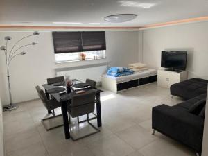 ein Wohnzimmer mit einem Sofa, einem Tisch und einem Bett in der Unterkunft Minalya Home in Laufenburg