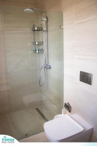 a bathroom with a shower with a toilet and a sink at Deluxe Condo/1BR-1BT/Close to Beach/Pool View in Punta Cana