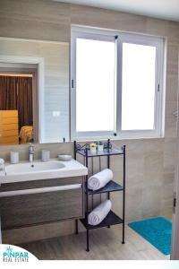 a bathroom with a sink and a mirror at Deluxe Condo/1BR-1BT/Close to Beach/Pool View in Punta Cana +16 photos