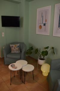 a living room with two tables and a couch at ΆLthea Apartment in Chalkida