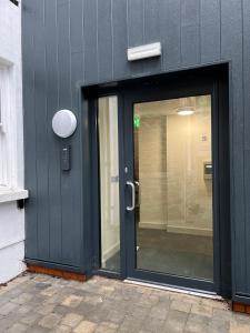 a black door with a window on a building at Sophia's Cwtch in Cardiff