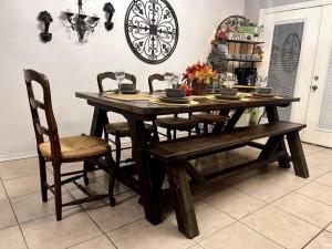 a dining room table with chairs and a clock on the wall at Rest, Relax & enjoy the entire cozy vacational home! in Mission
