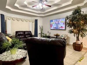 a living room with a couch and a ceiling fan at Rest, Relax & enjoy the entire cozy vacational home! in Mission