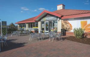 a restaurant with tables and chairs in front of a building at Kingfisher Quay Lodge in Clacton-on-Sea