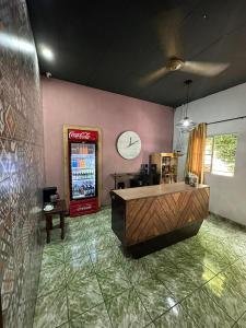 a room with a cocacola soda machine and a counter at hotel marsella in Sonsonate