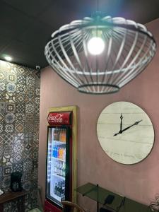a cocacola clock on the wall of a restaurant at hotel marsella in Sonsonate