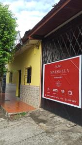 a sign on the side of a building at hotel marsella in Sonsonate