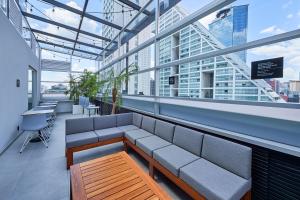 a seating area in a building with windows at City Express by Marriott Ciudad de México EBC Reforma in Mexico City