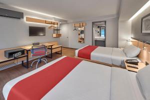 a hotel room with a large bed and a desk at City Express by Marriott Ciudad de México EBC Reforma in Mexico City