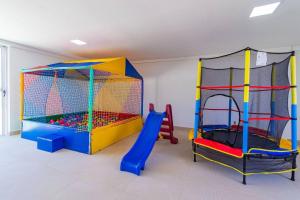 a play room with two play equipment in it at Makambira Residence no Centro de Porto de GalinhaS in Porto De Galinhas