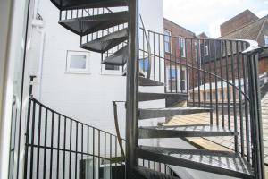 a spiral staircase leading up to a building at Spacious City Center 2 Bed Apartment Free Wifi in Lincoln