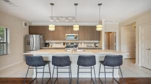a kitchen with a large island with bar stools at Ponce City Market 2 bdrm in Atlanta