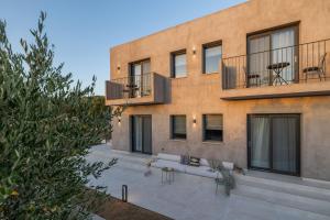 an exterior view of a building with a patio at Topos Suites in Lassi