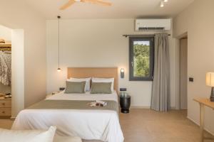 a bedroom with a dog laying on the bed at Topos Suites in Lassi