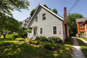 a white house with a yard at Home STEPS from Oberlin in Oberlin