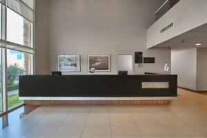 a lobby with a reception desk in a building at City Express by Marriott Puebla Angelopolis in Puebla
