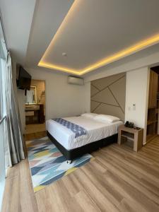 Giường trong phòng chung tại Grau Business Hotel