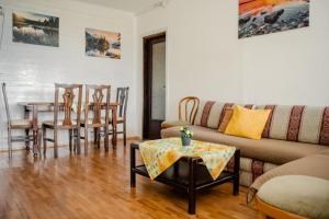 a living room with a couch and a table and chairs at Vacation home ROT Ohrid in Ohrid