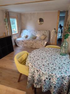 a living room with a table and a couch at Mobilhomes vintage dans ecolieux en cours camping a la ferme in Ponteilla