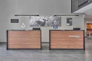 a pair of wooden doors in a room at City Express by Marriott Monterrey Lindavista in Monterrey