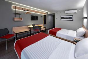 a hotel room with two beds and a desk at City Express by Marriott Monterrey Lindavista in Monterrey +28 photos