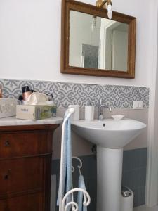 ein Bad mit einem Waschbecken und einem Spiegel in der Unterkunft La Falconiera in Vigevano