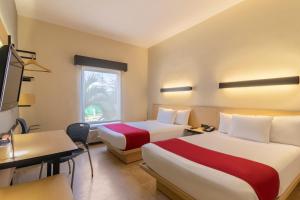 Postel nebo postele na pokoji v ubytování City Express by Marriott Cancun