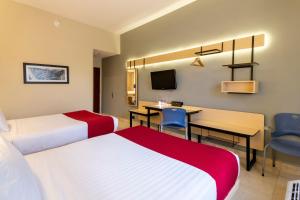 Postel nebo postele na pokoji v ubytování City Express by Marriott Cancun