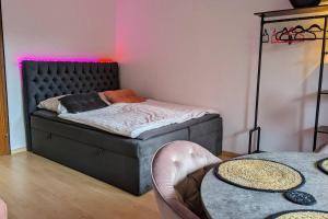 a bedroom with a bed with a pink light at ZAUBERFROSCH - ankommen und Zuhause fühlen - Apart-VL in Bad Liebenzell