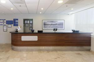 a lobby with a reception desk in a building at City Express by Marriott Nuevo Laredo in Nuevo Laredo