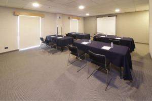 a conference room with black tables and chairs at City Express by Marriott Nuevo Laredo in Nuevo Laredo